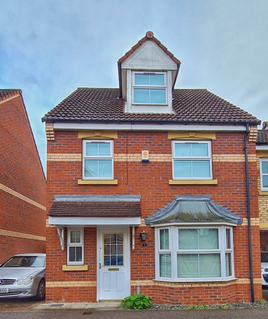 A three-storey red brick house with a bay window and a white front door, one of the properties Ryan owns and lets.